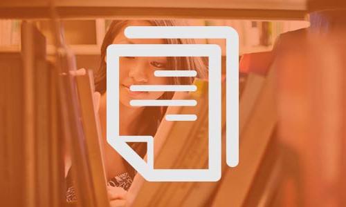 student looking through book shelf 